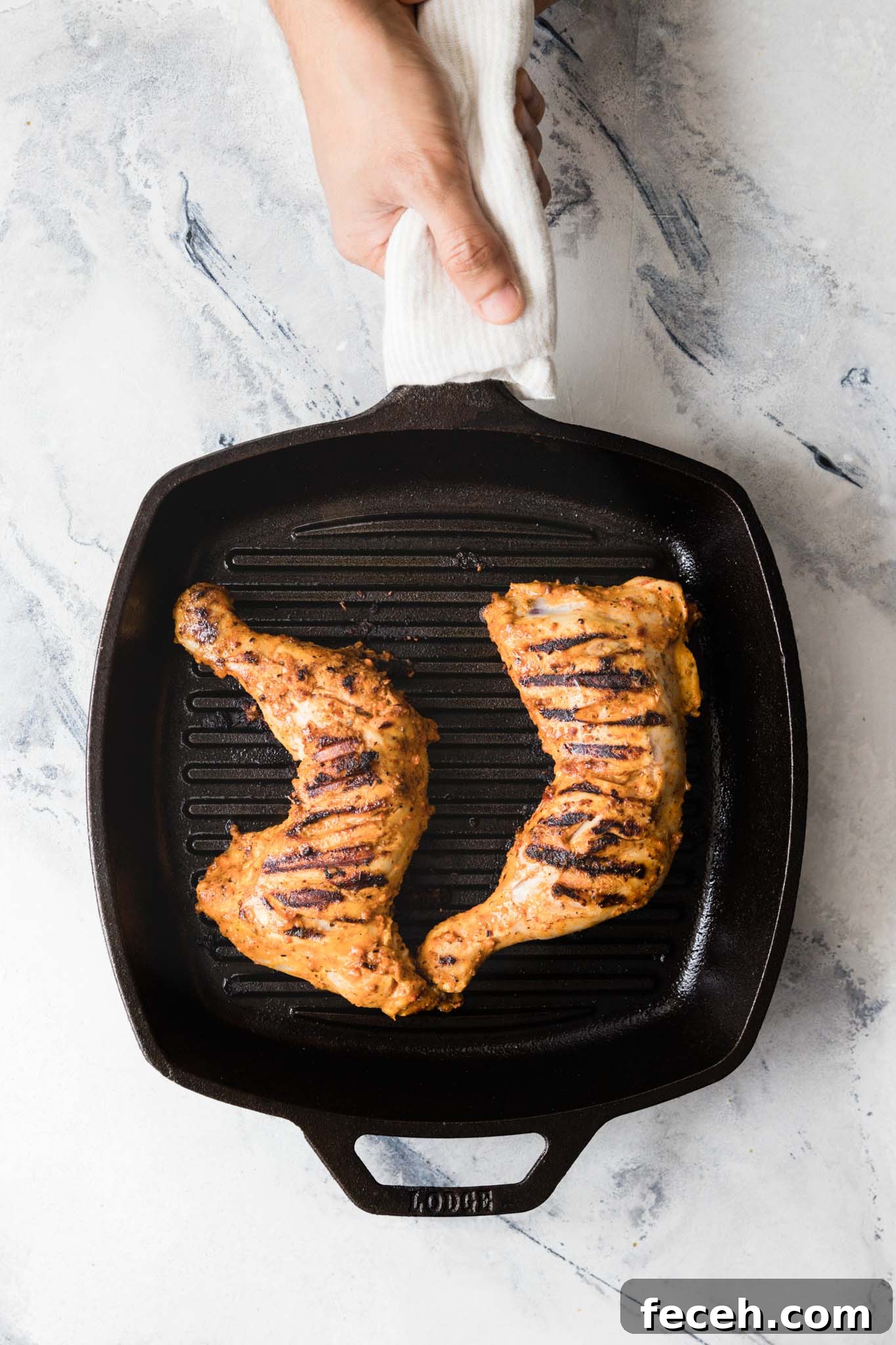 Holding a grill pan with chicken leg quarters