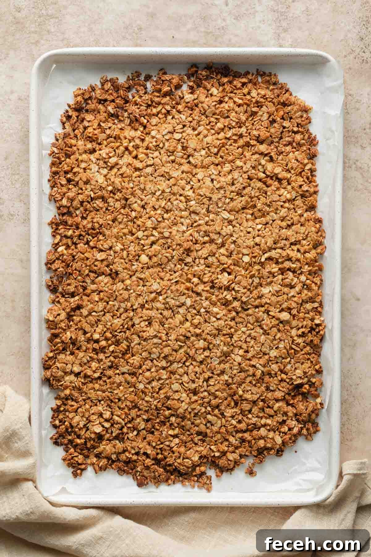 Baked granola cooling on the baking sheet.