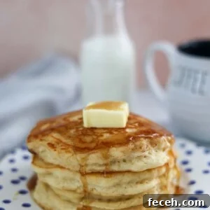 Fluffy Buttermilk Pancakes Recipe with Homemade Syrup 2 four buttermilk pancakes with butter and syrup on top.