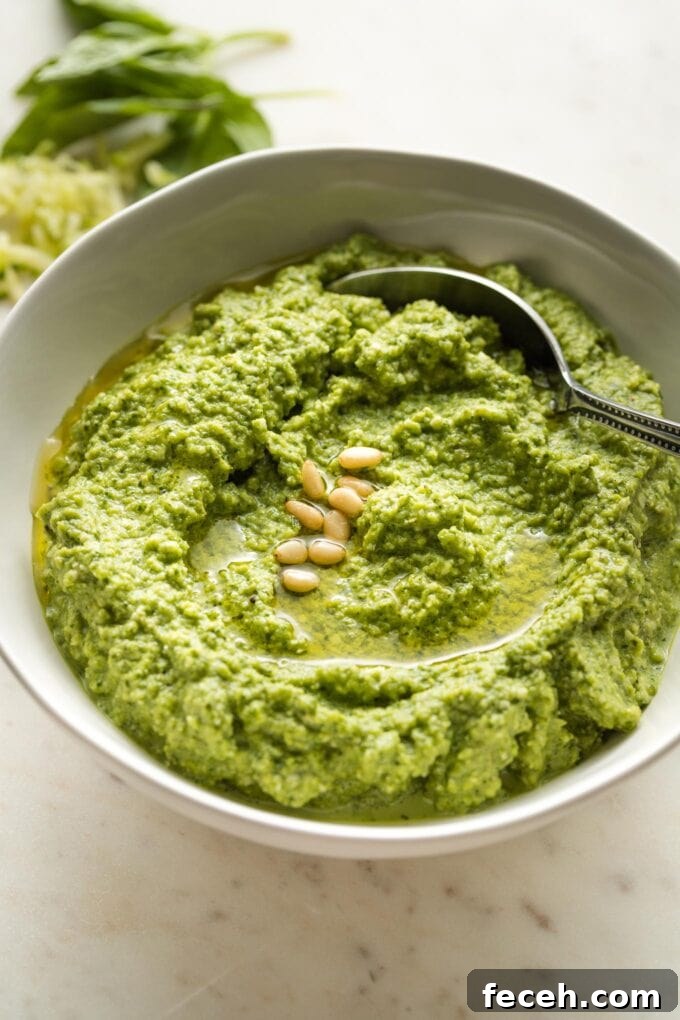 Small white bowl full of zucchini pesto.