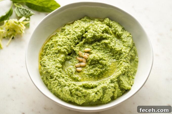 Small white bowl full of zucchini pesto.