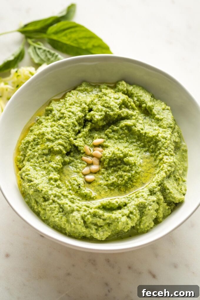 Small white bowl full of zucchini pesto.