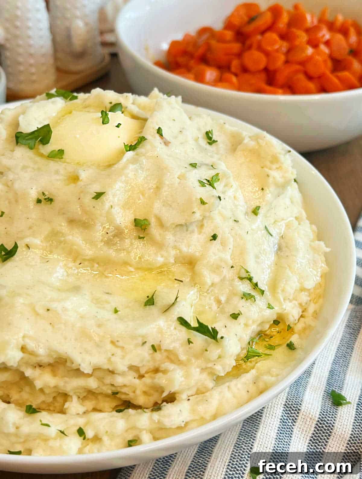 cream cheese mashed potatoes with butter in serving bowl.