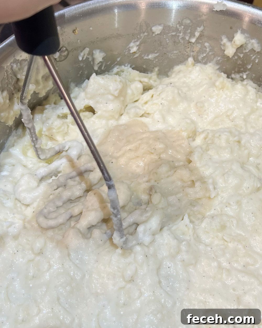 potato masher mashing potatoes.