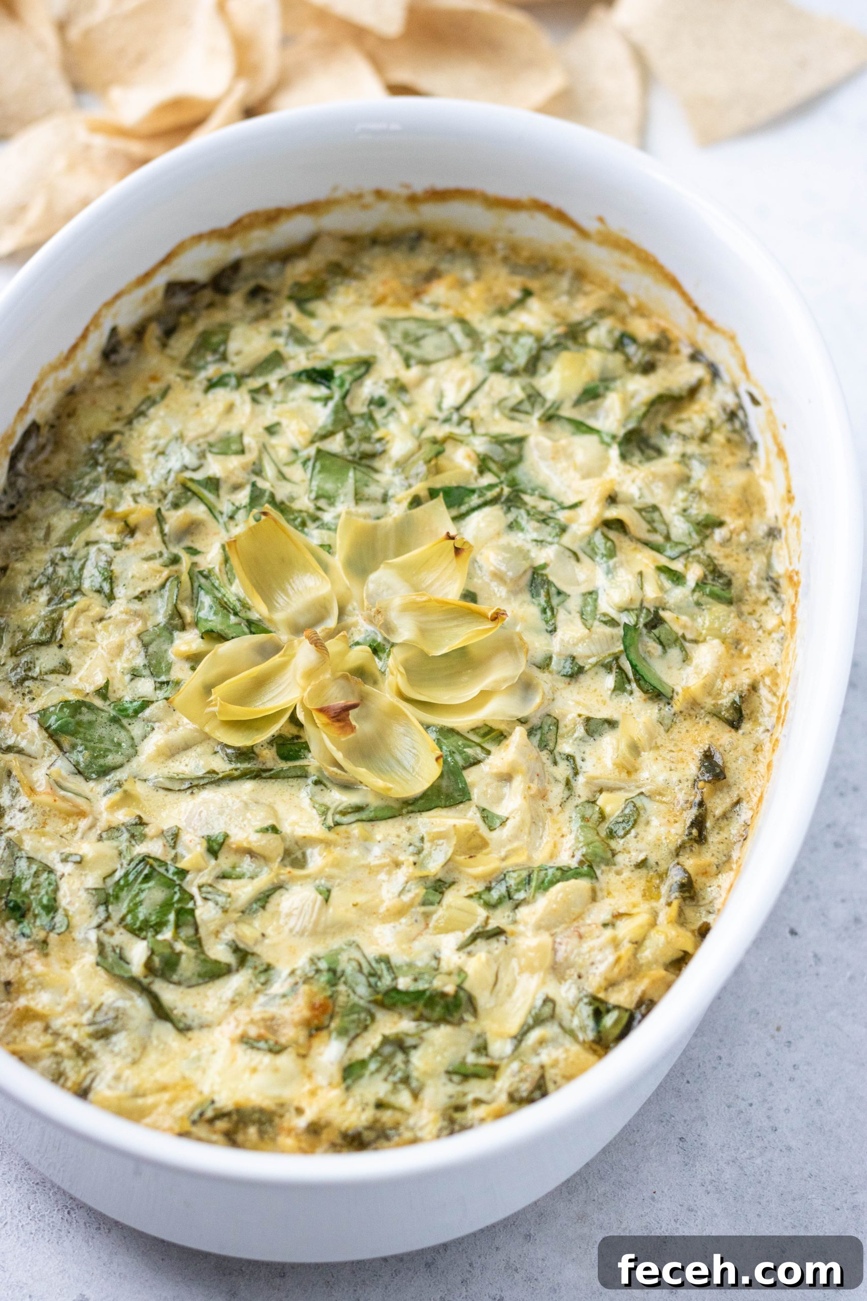 spinach artichoke dip in a round casserole dish 
