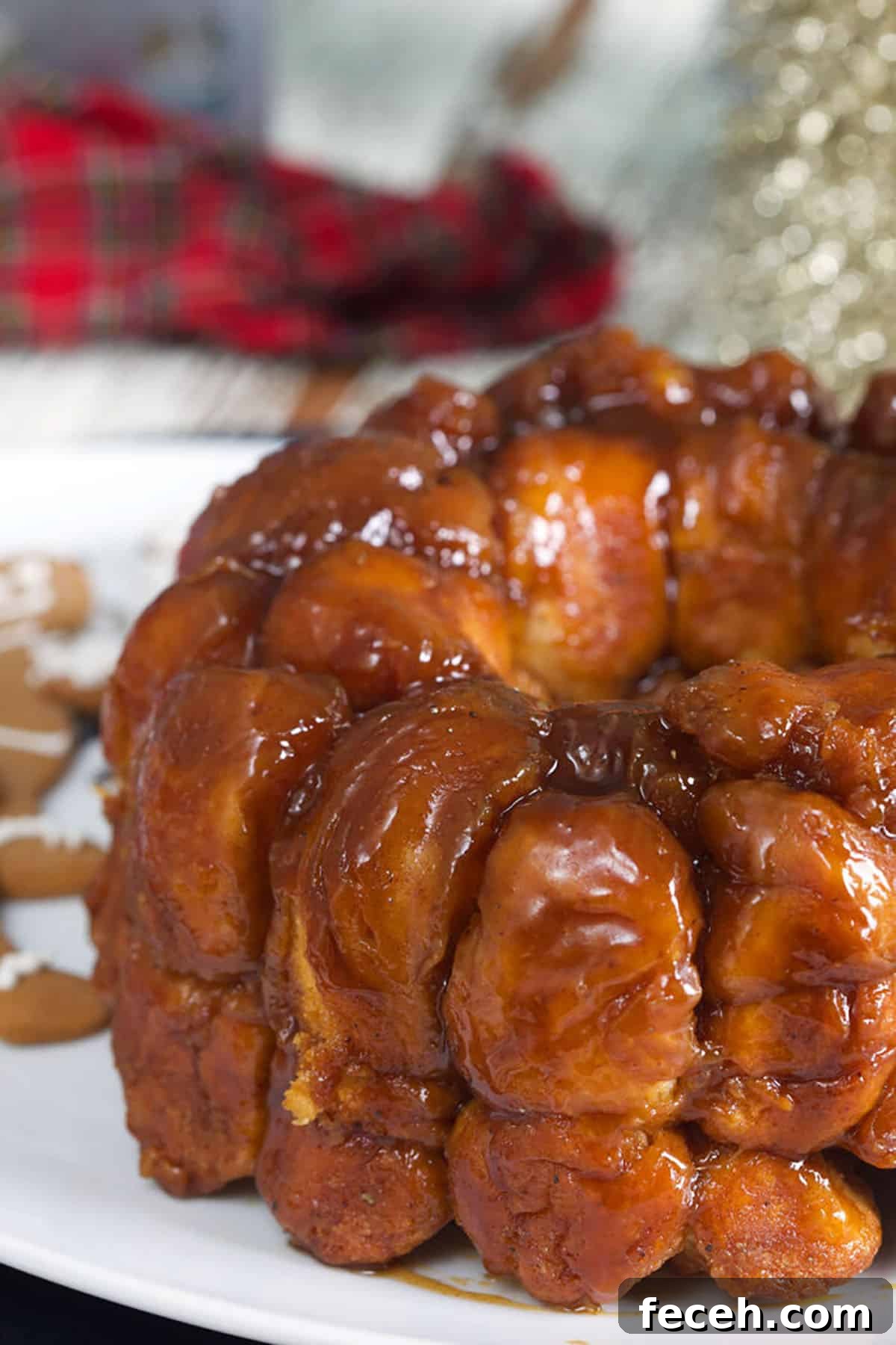 Baked monkey bread is presented on a round white serving platter.