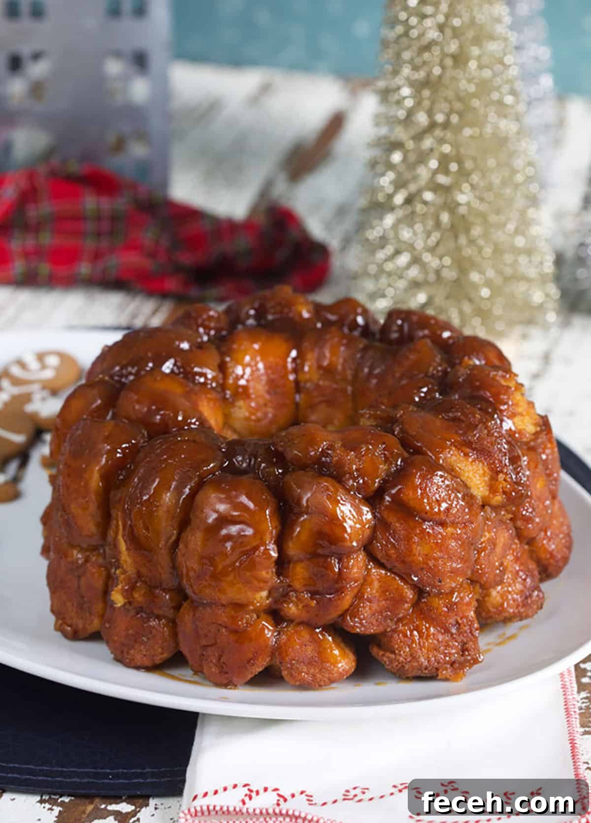 A ring of baked monkey bread on a white platter is ready to eat.