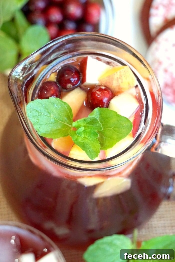 Sparkling cranberry sangria mocktail or cocktail recipe that looks and tastes amazing! Either way it's tasty for the holidays and year round. sparkling cranberry sangria