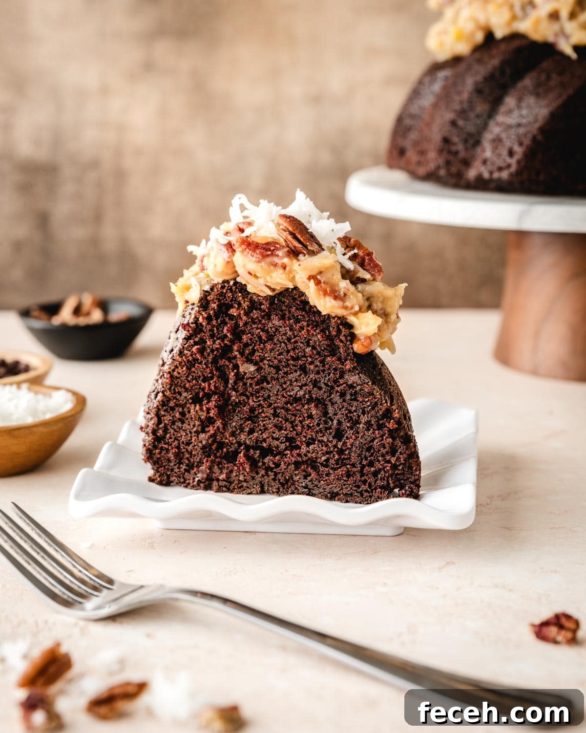 Slice of German Chocolate Pound Cake with Pecan-Coconut Frosting on top.