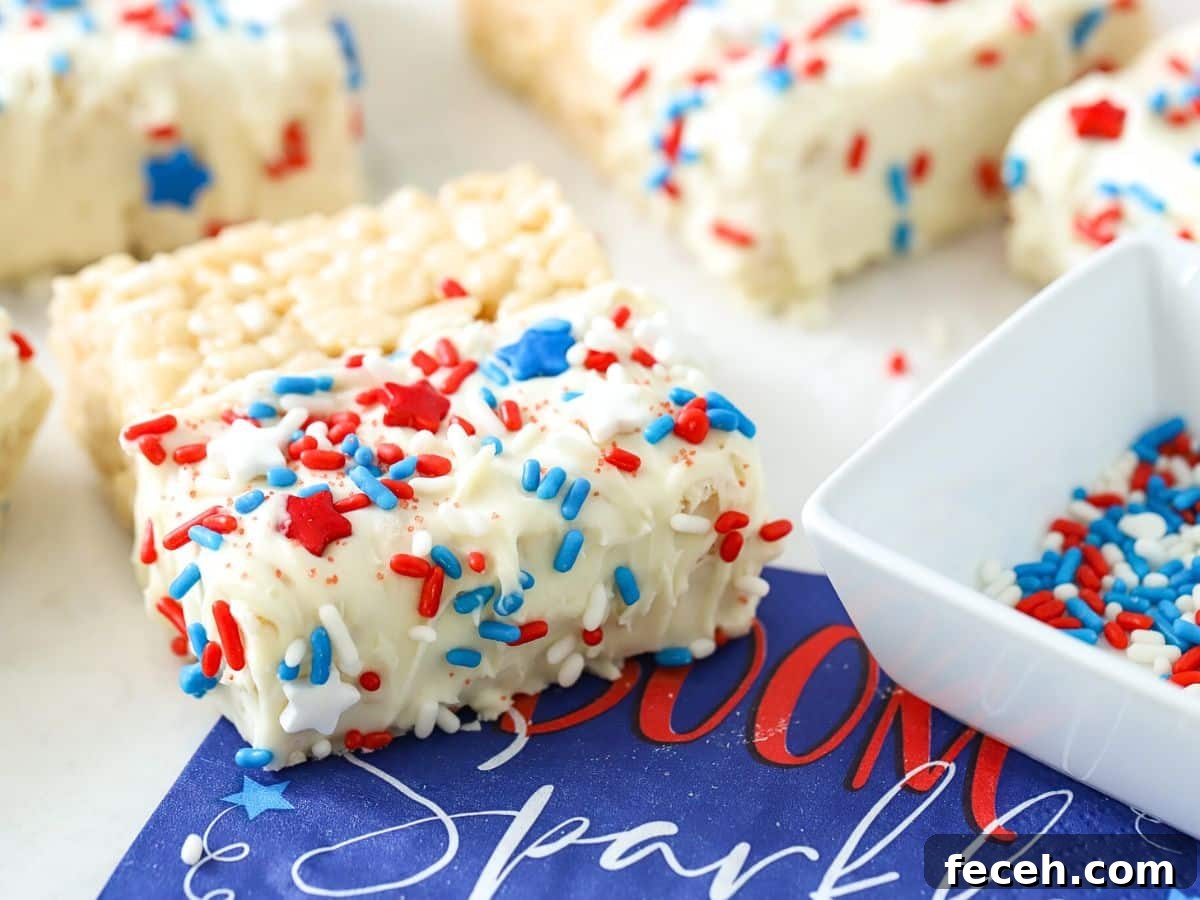 Fourth of July Rice Krispie Treats: Patriotic Red, White & Blue Recipe 2 Rice Krispie treats with red, white, and blue sprinkles.
