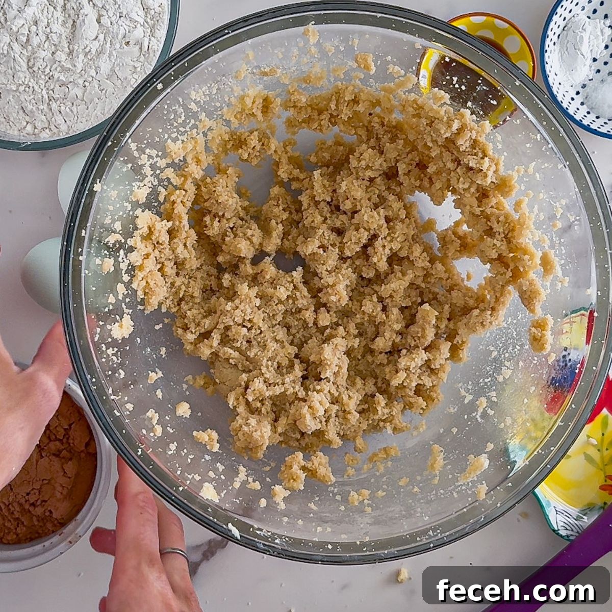 Mixing the sugar and butter together in a bowl.