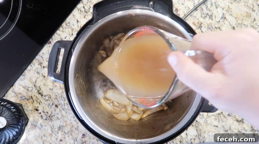 Instant Pot Birria Quesabirria Tacos Recipe 14 Pour in some broth...