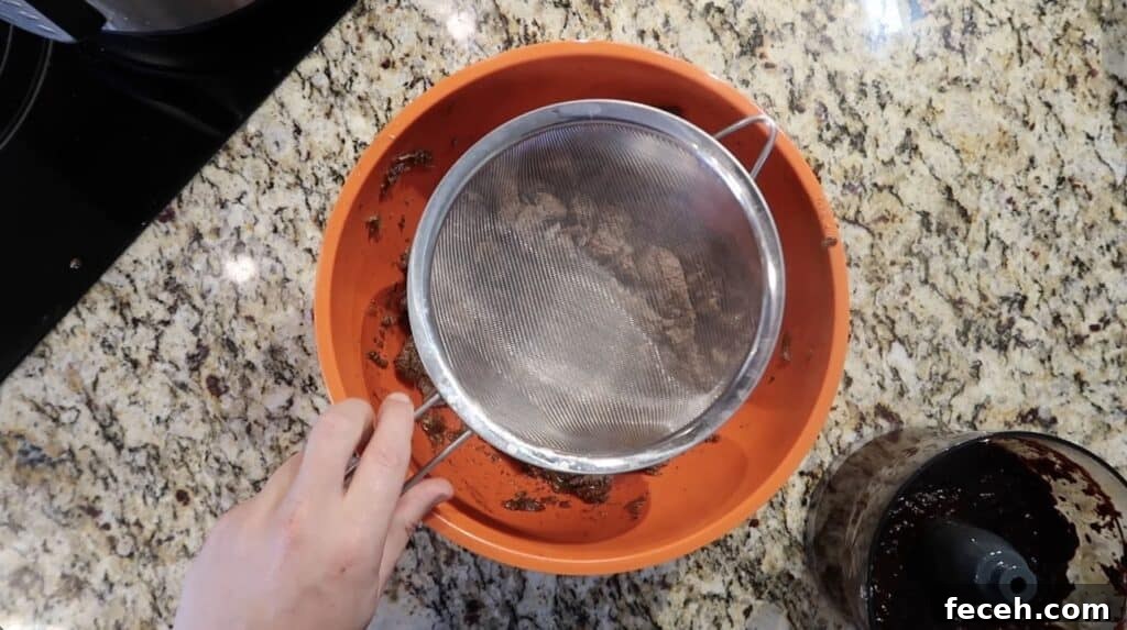Instant Pot Birria Quesabirria Tacos Recipe 22 Now, take a fine-mesh strainer and place it over the bowl with the shredded meat...