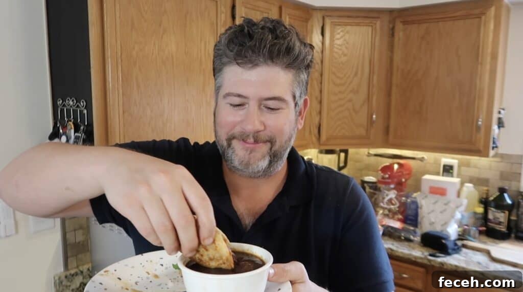 Instant Pot Birria Quesabirria Tacos Recipe 29 Man dipping taco
