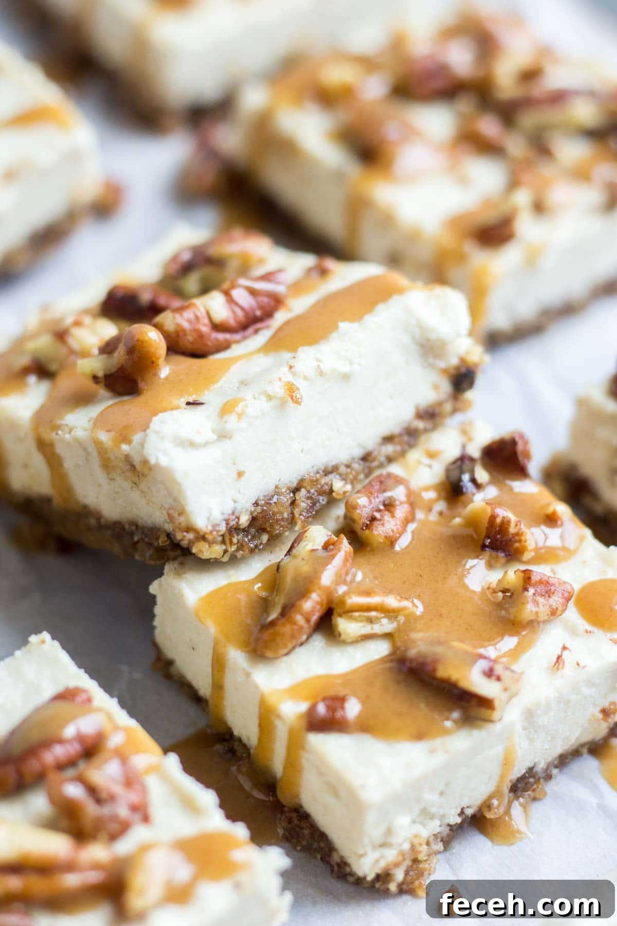 Smooth and creamy, these turtle vegan cheesecake bars are an easy and no bake healthy dessert. The crust is made with pecans and dates and the silky vegan cheesecake is topped with paleo caramel and pecans. You won't believe how yummy an easy it is to make!