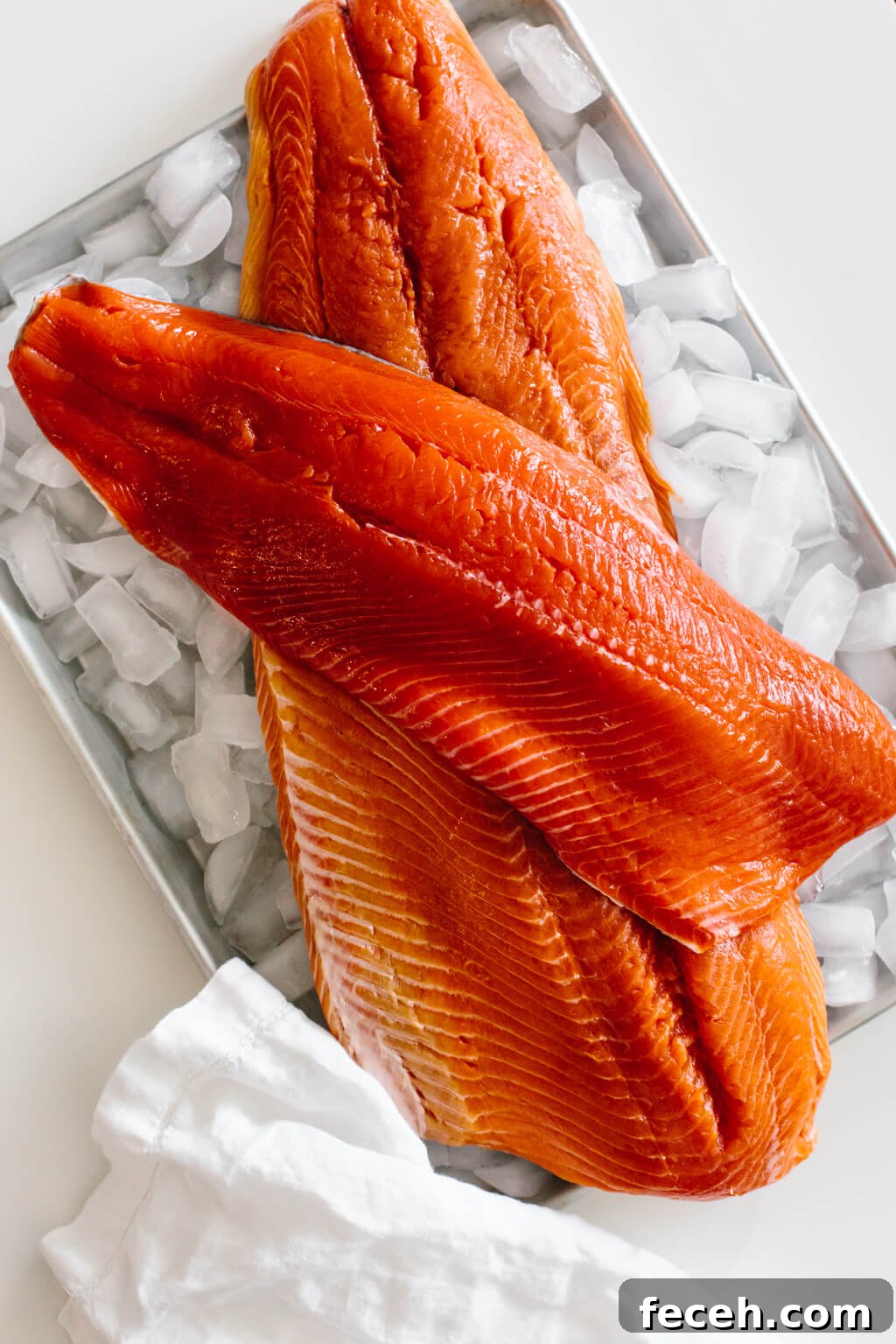 Ever wonder the difference between Coho Salmon, Sockeye Salmon and King Salmon? Raw salmon filets on a tray of ice.