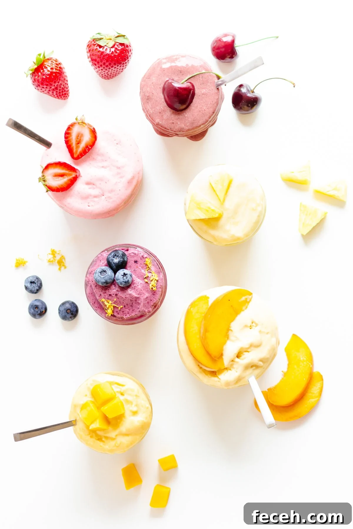 No-Fuss Blender Ice Cream Recipe: Creamy 5-Minute Treat 2 Overhead photo of six different flavors of blender ice cream in jars with fruit scattered around.