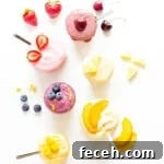 Overhead image of six different flavors of blender ice cream in jars with fruit garnishes.