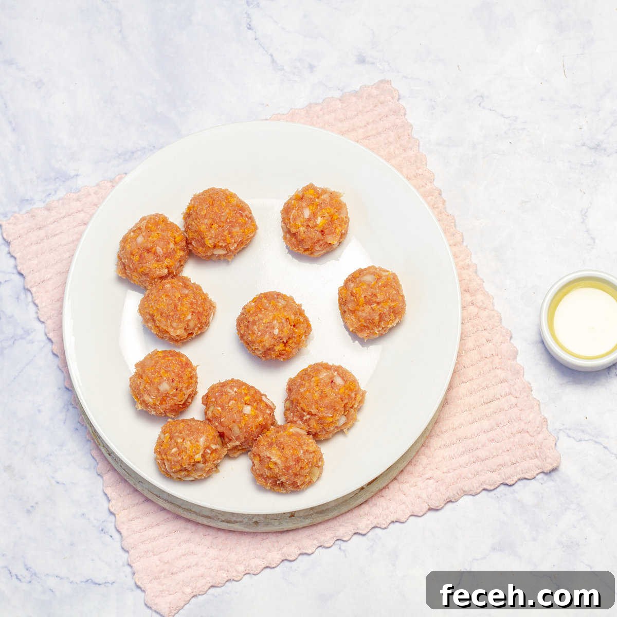 Uncooked Pesto Chicken Meatballs in a plate