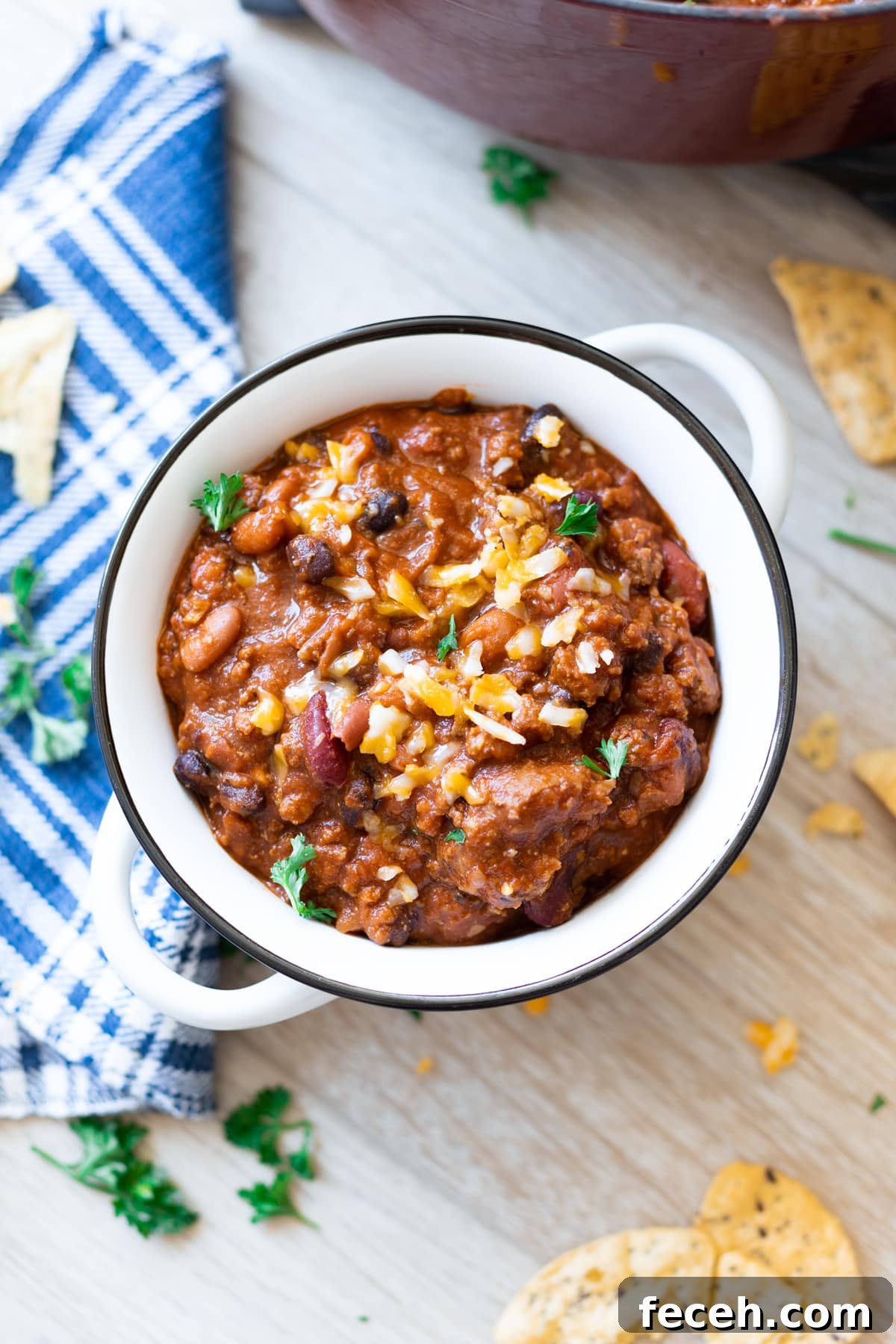 Hearty Three-Bean Chili Recipe: Simple Weeknight Dinner 13 Bowl of chili topped with cheese and onions.