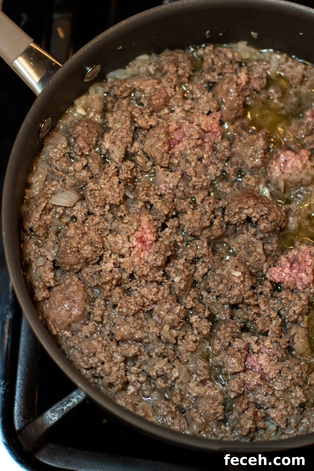 Hearty Three-Bean Chili Recipe: Simple Weeknight Dinner 5 Ground beef and onions browning in a skillet.