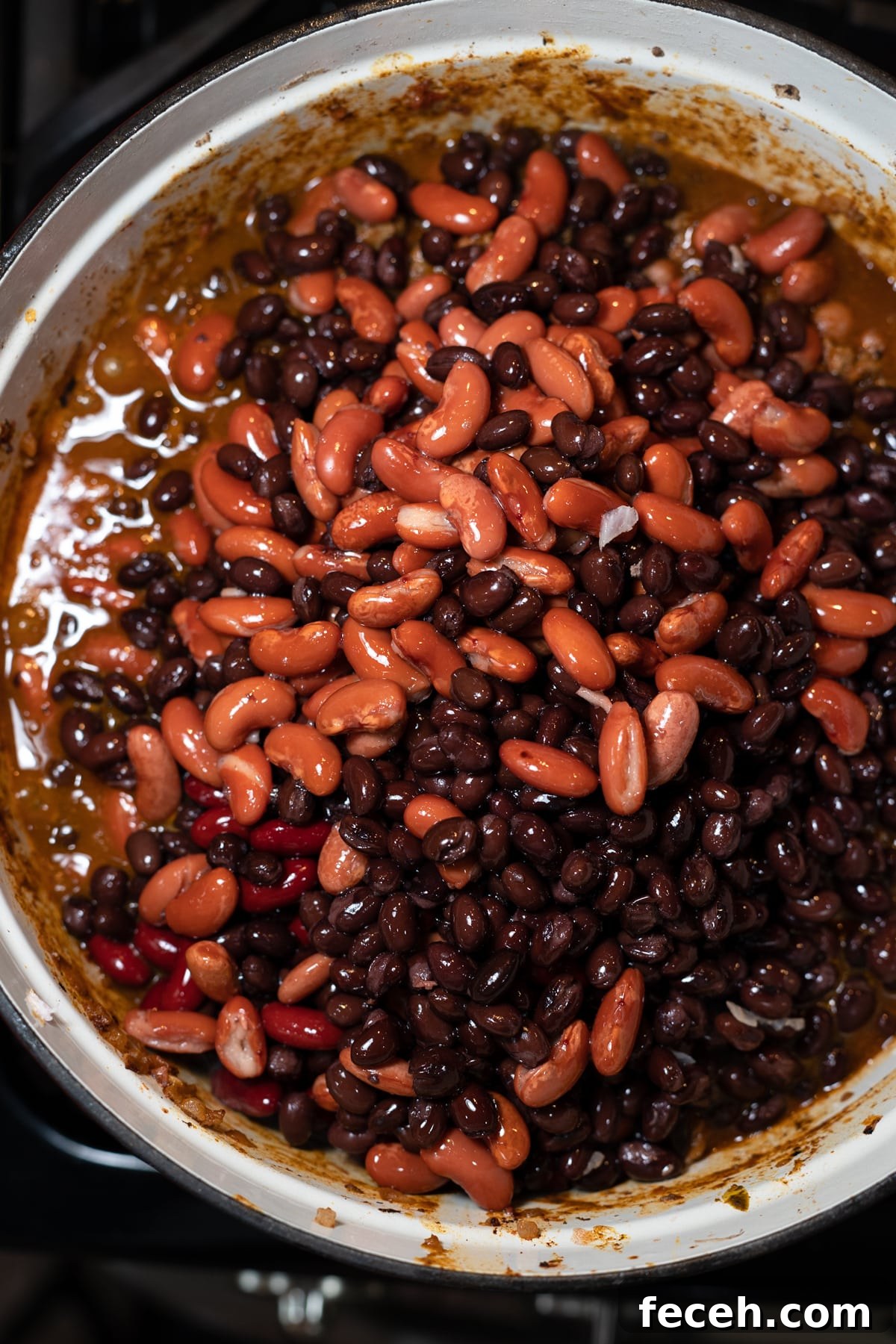 Hearty Three-Bean Chili Recipe: Simple Weeknight Dinner 9 Different type of chili beans in a large pot.