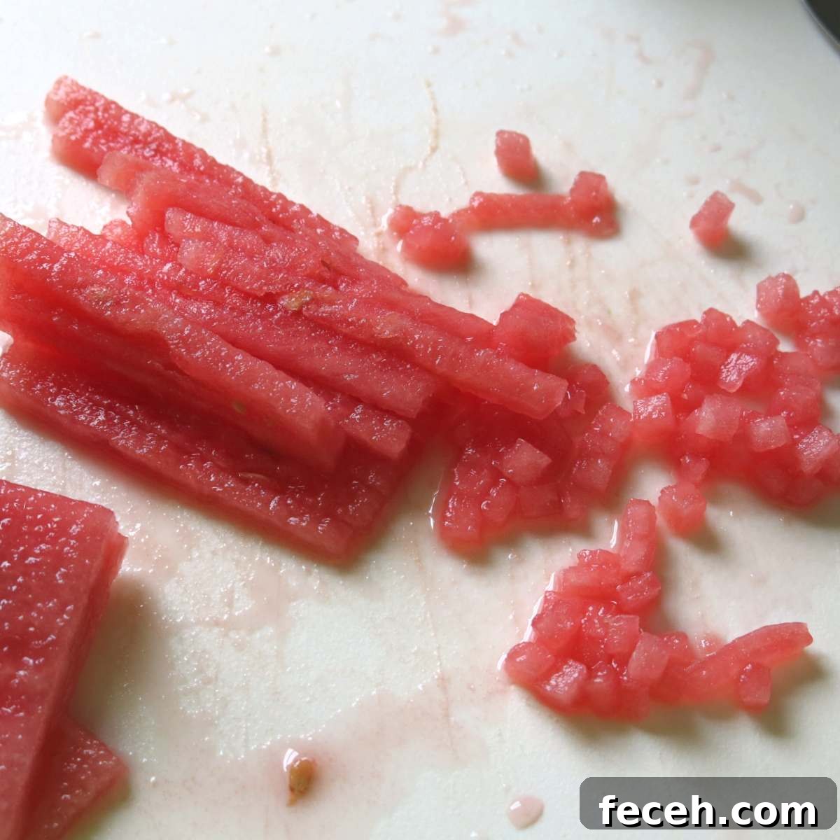 Summer Fennel Salad with Feta, Watermelon and Toasted Pecans 6 Long skinny rectangular pieces of watermelon partially diced.