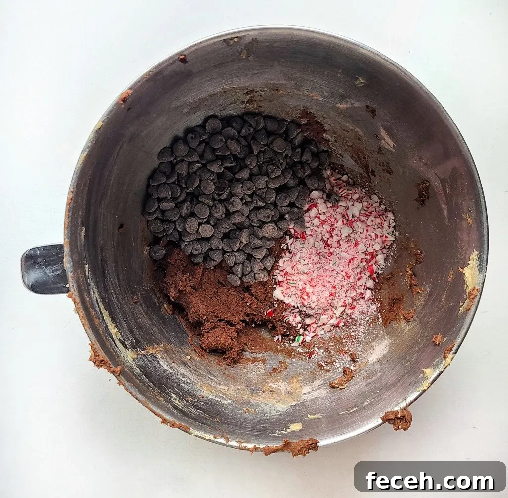 Add in the chocolate and crushed candy canes.
