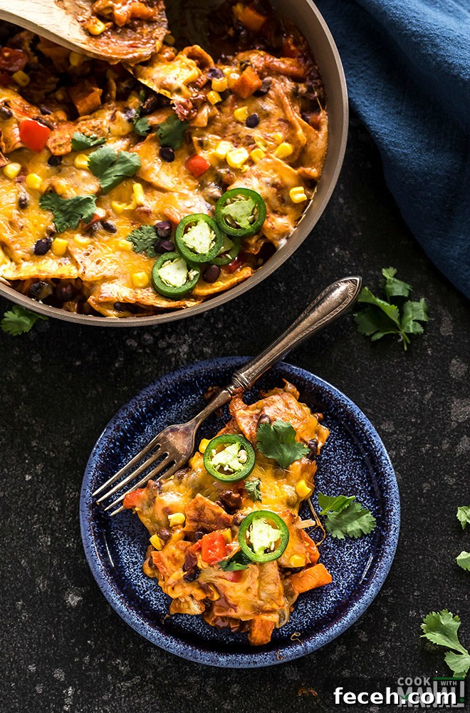 One-Pot Veggie Enchiladas with Cheesy Sauce 5 vegetarian enchiladas served in a blue round plate with a fork and a pan of enchiladas in the background