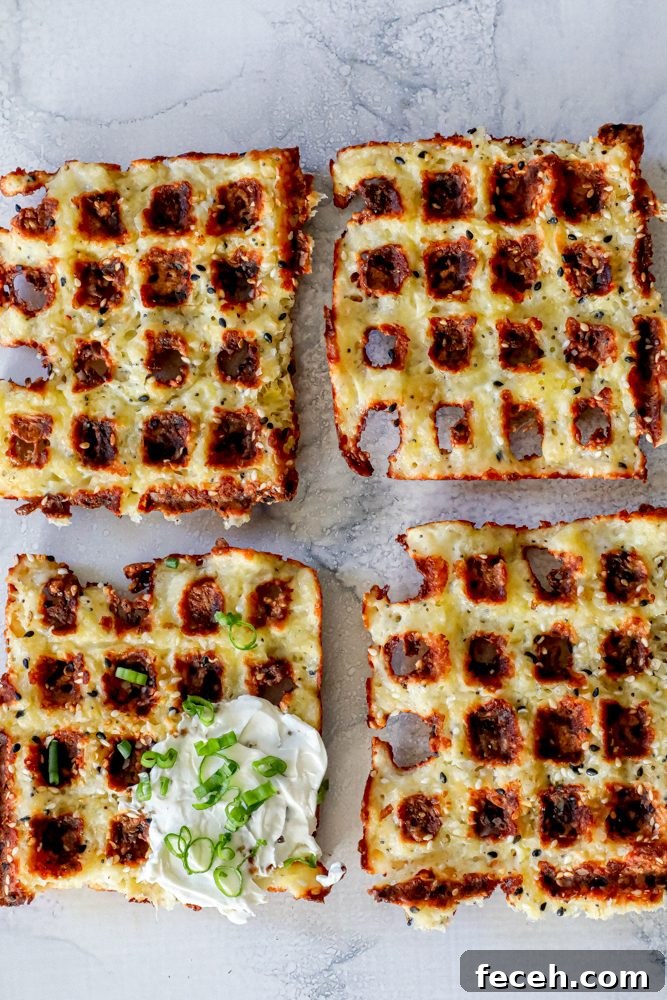 Ultimate Keto Chaffle Recipes: Savory & Sweet Ways to Use Chaffles 3 4 keto chaffle waffles on a countertop with sour cream and green onions on one of them.