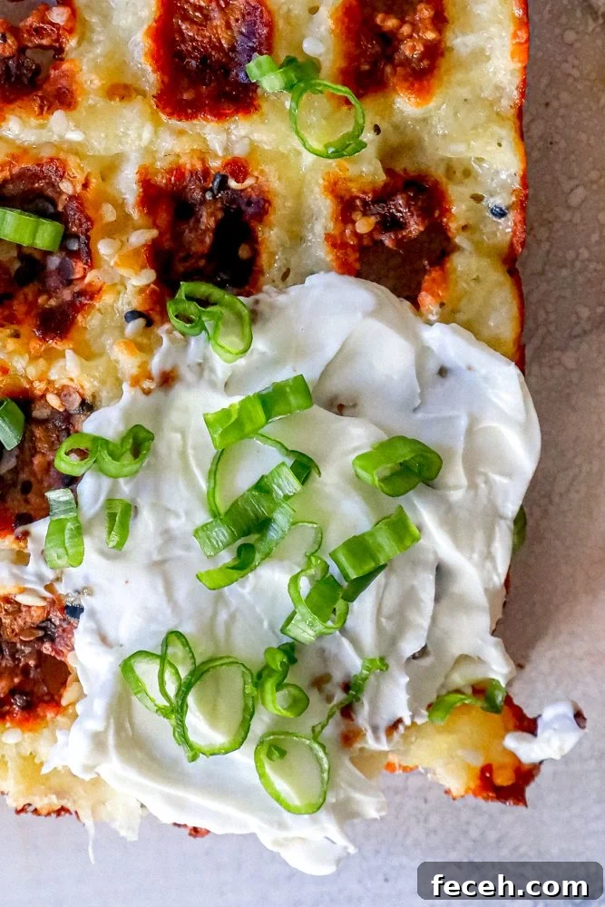 Ultimate Keto Chaffle Recipes: Savory & Sweet Ways to Use Chaffles 4 keto chaffle waffles on a countertop with sour cream and green onions