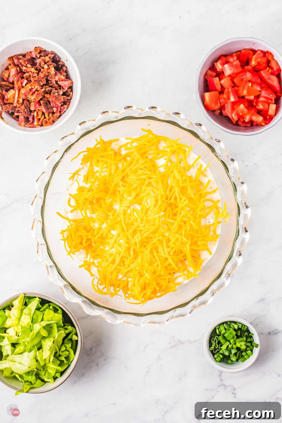 cheese in a bowl with small bowl of lettuce