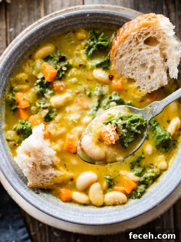 Spoon with a scoop of Tuscan white bean soup.