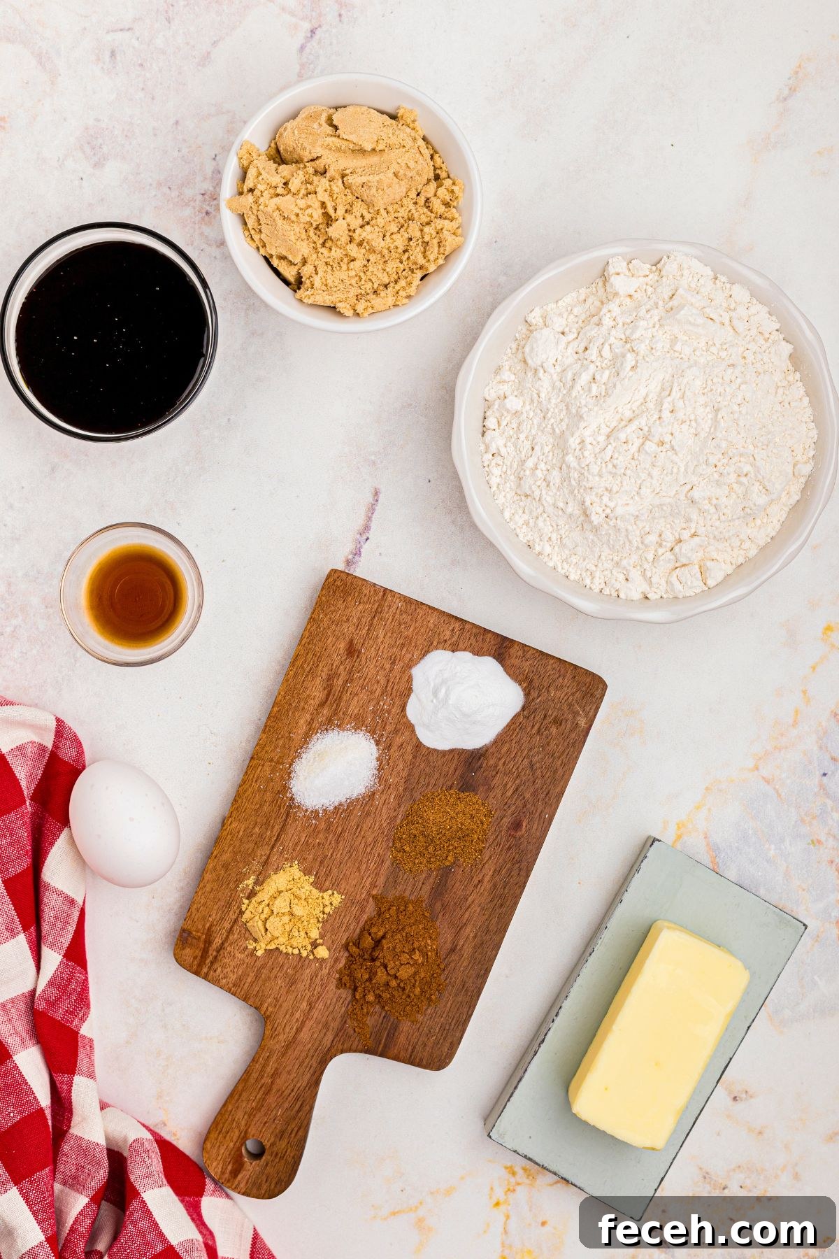 Classic Gingerbread Cookie Recipe for Soft, Spiced Cookies 3 Ingredients needed to make gingerbread cookies measured in small dishes, on a marble table.