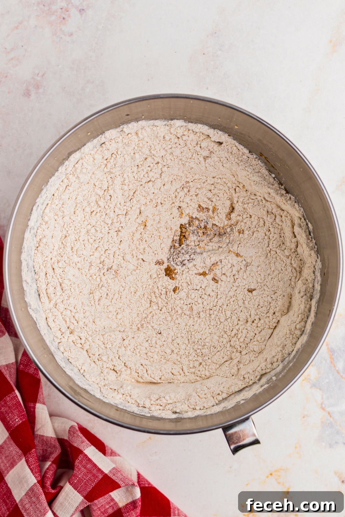 Classic Gingerbread Cookie Recipe for Soft, Spiced Cookies 4 Flour and other dry ingredients mixed together in a silver mixing bowl.