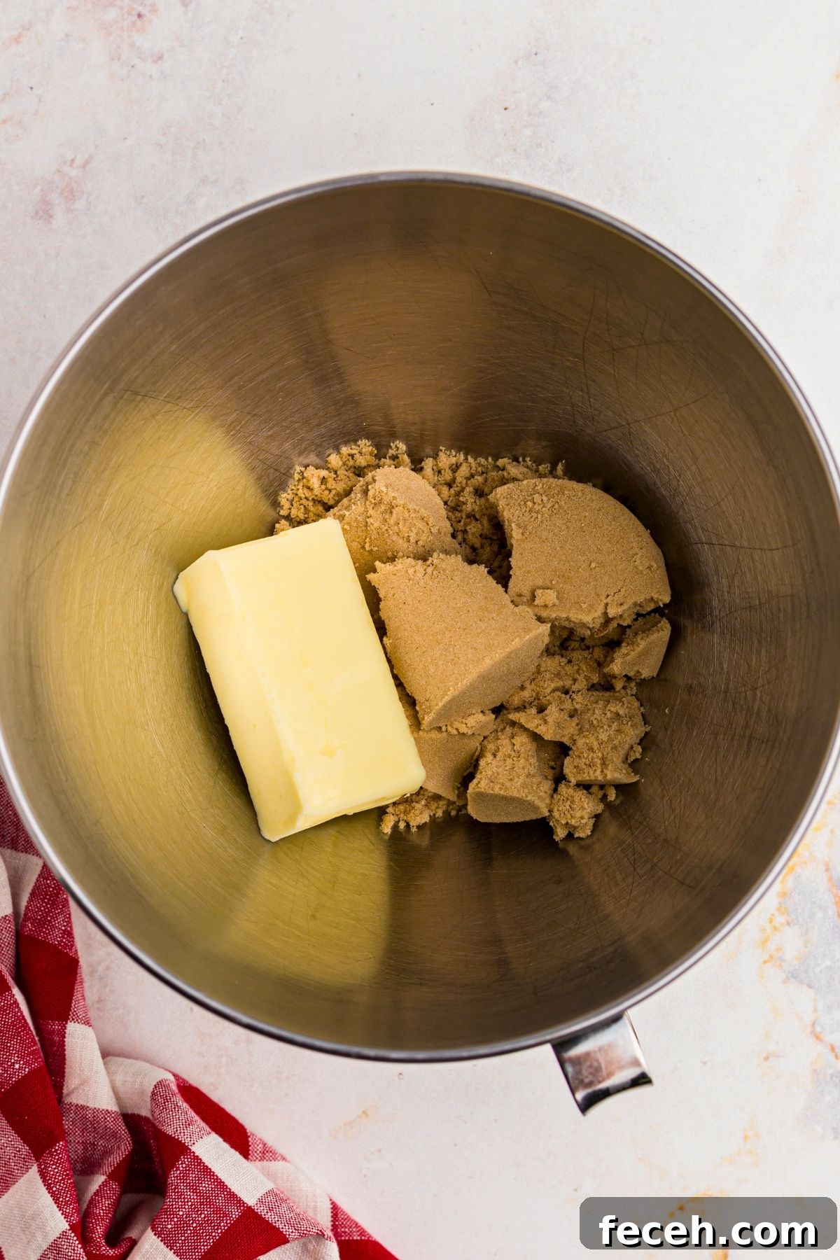 Classic Gingerbread Cookie Recipe for Soft, Spiced Cookies 5 Butter and brown sugar in a silver mixing bowl before mixing together.