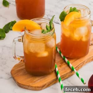Two cups of iced tea on a wooden board.