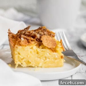 noodle kugel on plate with a fork and mug in background