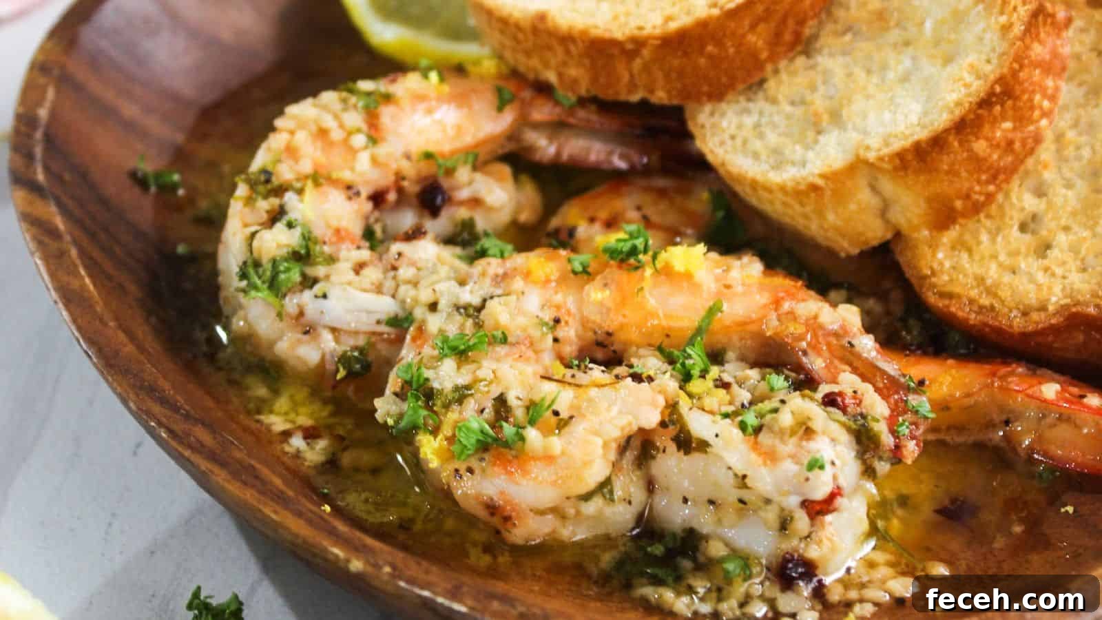 A plate with shrimp and bread on it.