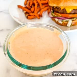 In-N-Out Spread Copycat Recipe: How to Make the Famous Sauce 9 In n Out sauce in a small glass bowl in front of a plated In and Out cheeseburger and fries.