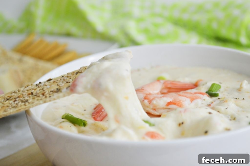 Creamy Cajun Shrimp Dip Made in the Instant Pot 3 Cajun Shrimp Dip with cracker pulling cheese