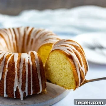 baked and glazed cake with slice on cake server
