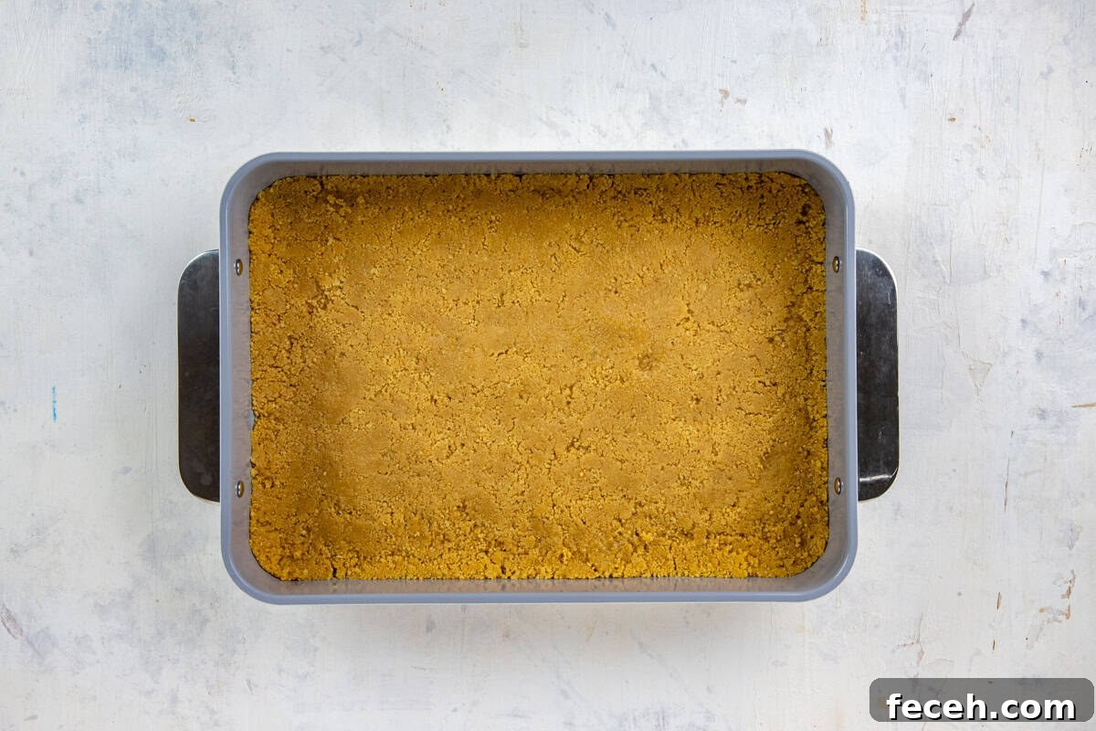 Creamy Lemon Lush Dessert Recipe for Every Occasion 5 Cookie mixture pressed into the bottom of a 9x13-inch baking pan.