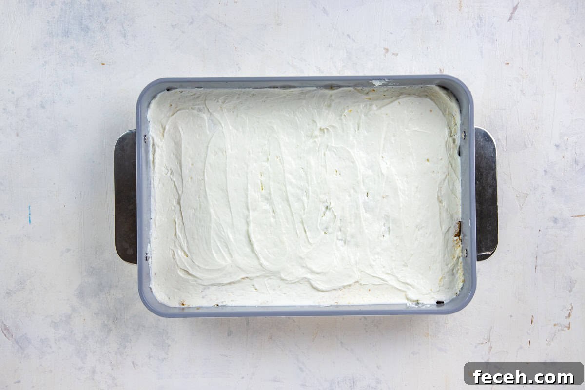 Creamy Lemon Lush Dessert Recipe for Every Occasion 7 Cream cheese mixture spread on top of the cookie crust a 9x13-inch baking pan.