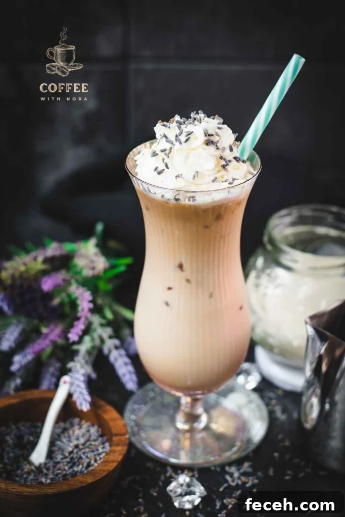Iced Lavender Latte Recipe: How to Make a Floral Cold Coffee Drink 2 Gorgeous Hurricane glass, filled with crushed lavender iced latte, topped with whipped cream and sprinkled with lavender buds. Served with a turquoise white striped drinking straw.