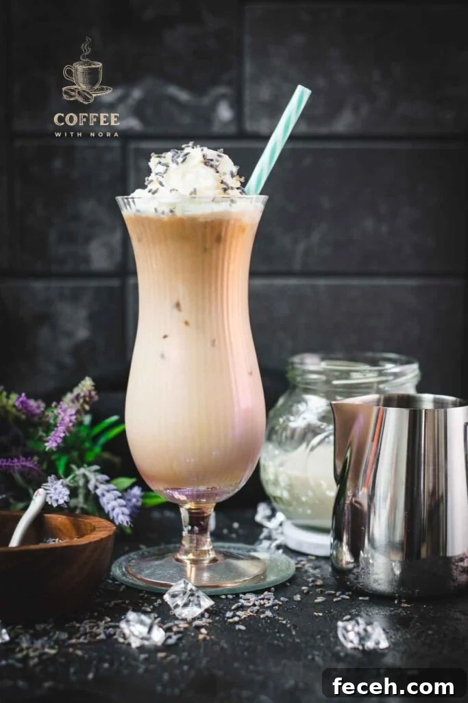 Iced Lavender Latte Recipe: How to Make a Floral Cold Coffee Drink 11 Gorgeous Hurricane glass, filled with crushed lavender iced latte, topped with whipped cream and sprinkled with lavender buds. Served with a turquoise white striped drinking straw.