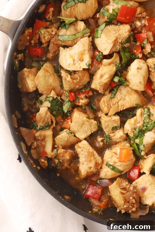 Thai Basil Chicken Stir-Fry Recipe with Garlic and Chilies 2 thai basil chicken stir fry in a pan, a delicious stir fry chicken with basil that tastes like it came from your favorite thai restaurant.
