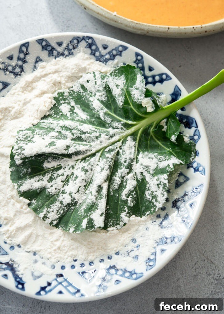 Kale leaf lightly coated with flour before dipping in gochujang batter