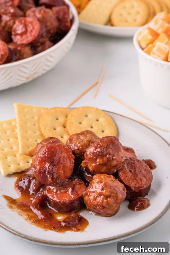 cranberry chipotle meatballs and sausage on plate with crackers