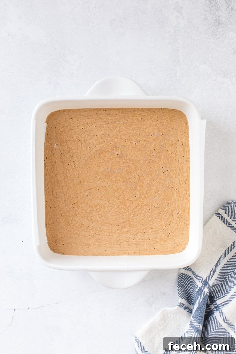 Creamy Peanut Butter Fudge Recipe for Rich, No-Bake Treats 5 The fudge batter inside the prepared pan.